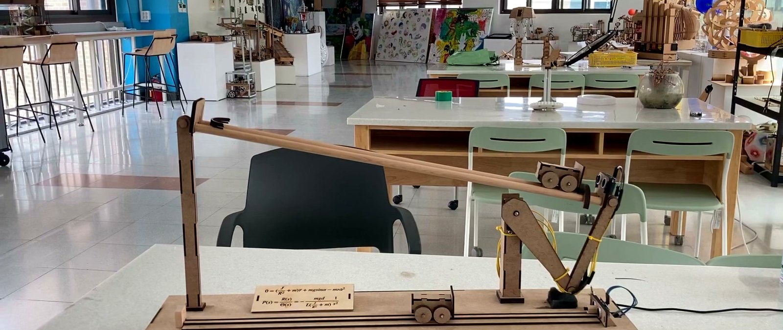 The wooden ball-and-beam rig balancing a ball under PID control